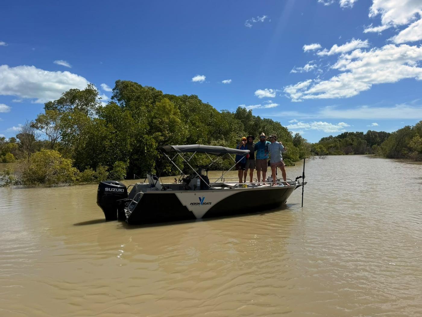 Ultra V on a tidal river under a blue sky