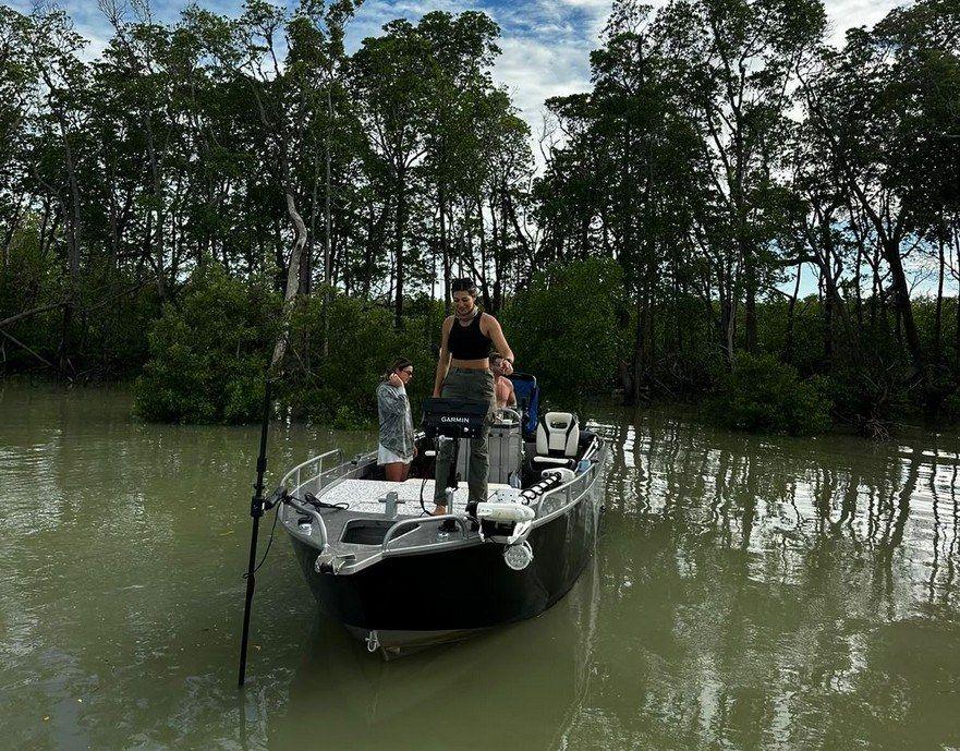 Angler on the casting platform in a mangrove creek